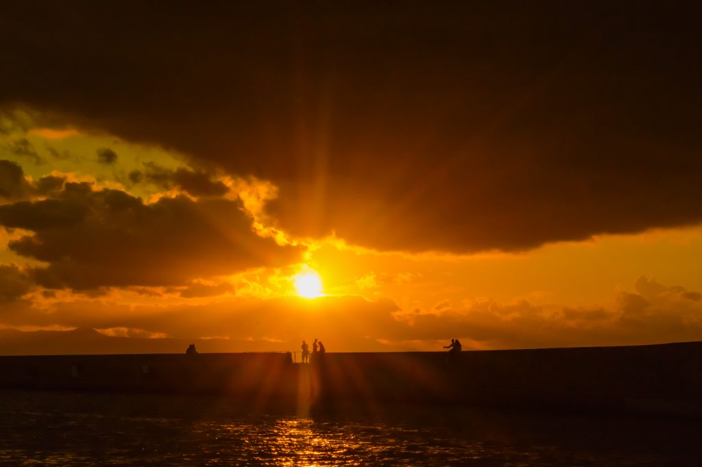 Sunset over the harbour walls