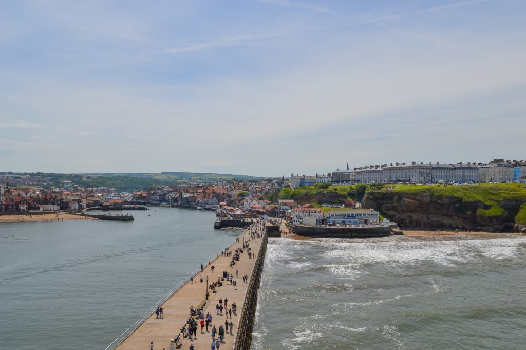 View from the lighthouse. Calm water in the harbour on the lefthand side.