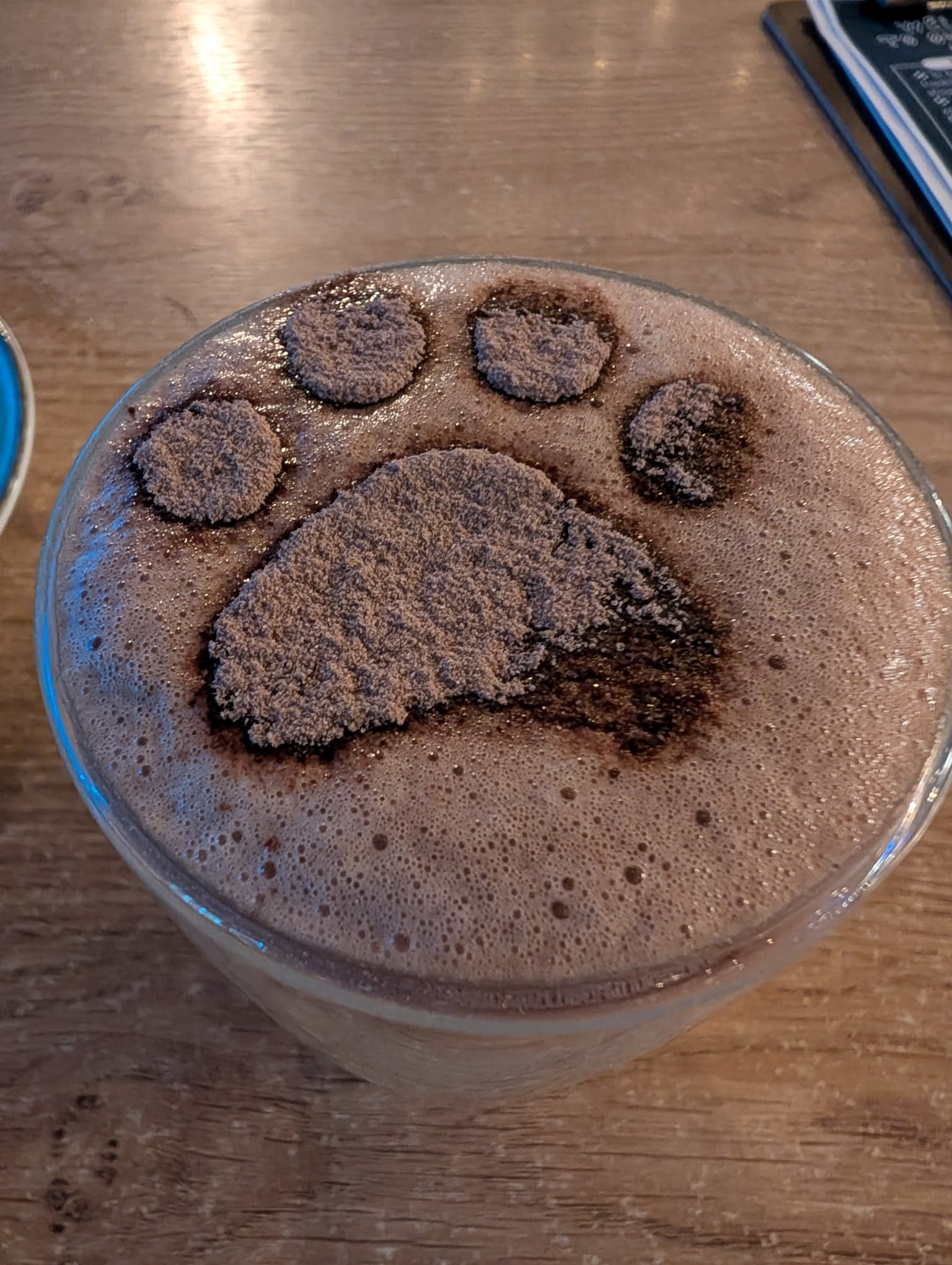 Hot chocolate topped with a cocoa paw-print design