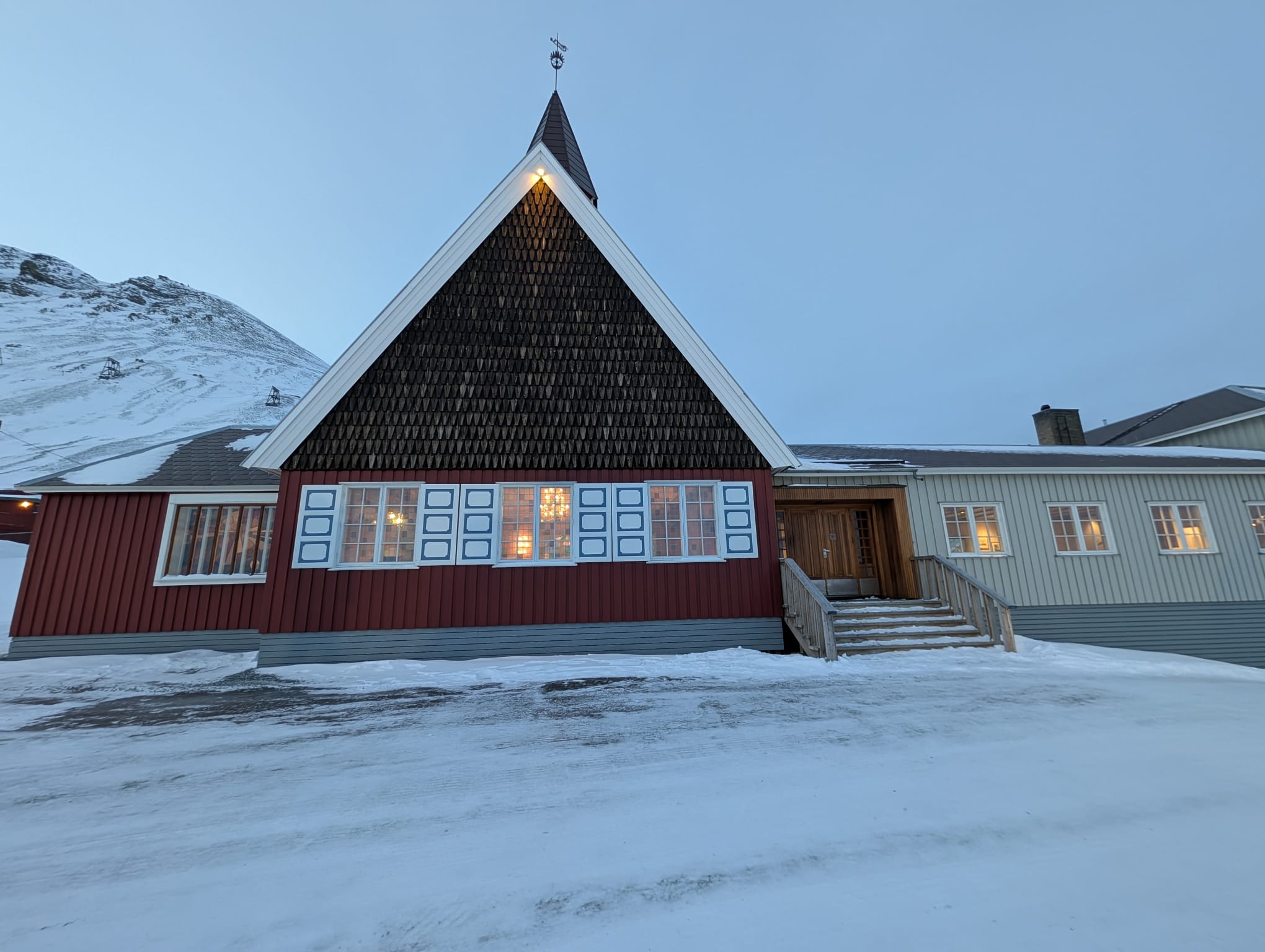 Front of Svalbard Church against a blue winter sky