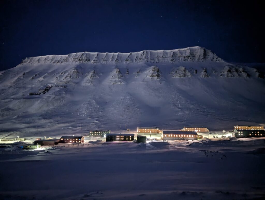 Longyearbyen Svalbard during Polar Night with snow-covered mountains.