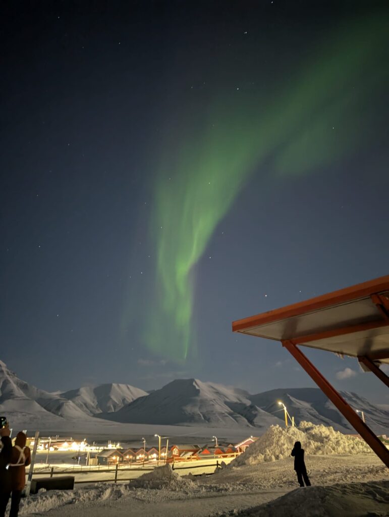 Northern Lights over snowy mountains in Longyearbyen Svalbard during Polar Night